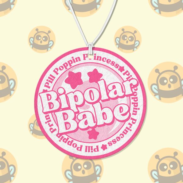 This image shows an adorable hand-drawn air freshener, Bipolar Babe Pink Air Freshener, which is available to purchase from HunnieByte.com