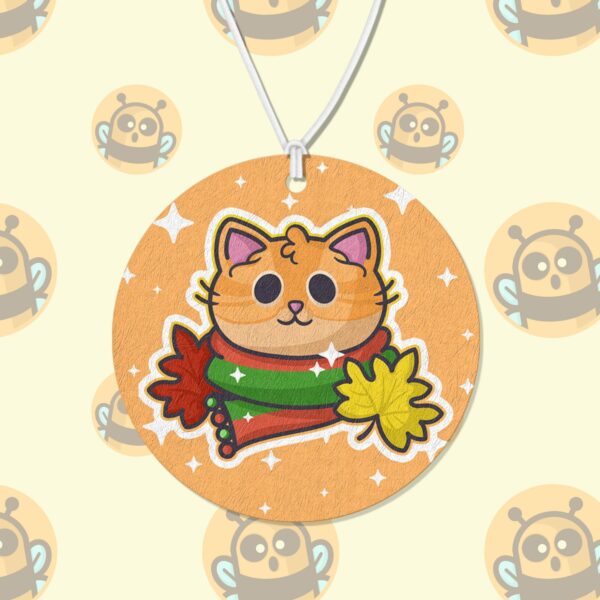 This image shows an adorable hand-drawn air freshener, Autumn Ginger Kitty Air Freshener, which is available to purchase from HunnieByte.com