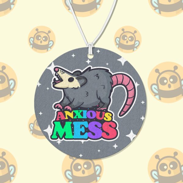 This image shows an adorable hand-drawn air freshener, Anxious Mess Possum Air Freshener, which is available to purchase from HunnieByte.com