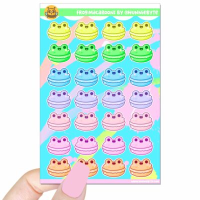 This image shows an adorable hand-drawn sticker sheet, Rainbow Frog Macaroons Sticker Sheet, which is available to purchase from HunnieByte.com