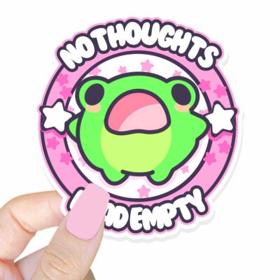 This image shows an hand-drawn adorable sticker, No Thoughts Head Empty Frog Sticker, which is available to purchase from HunnieByte.com