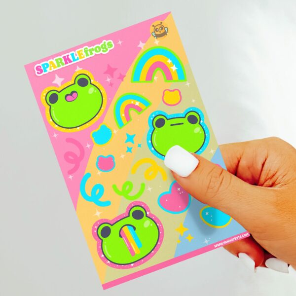 This image shows an adorable hand-drawn sticker sheet, Sparkle Frogs Sticker Sheet, which is available to purchase from HunnieByte.com