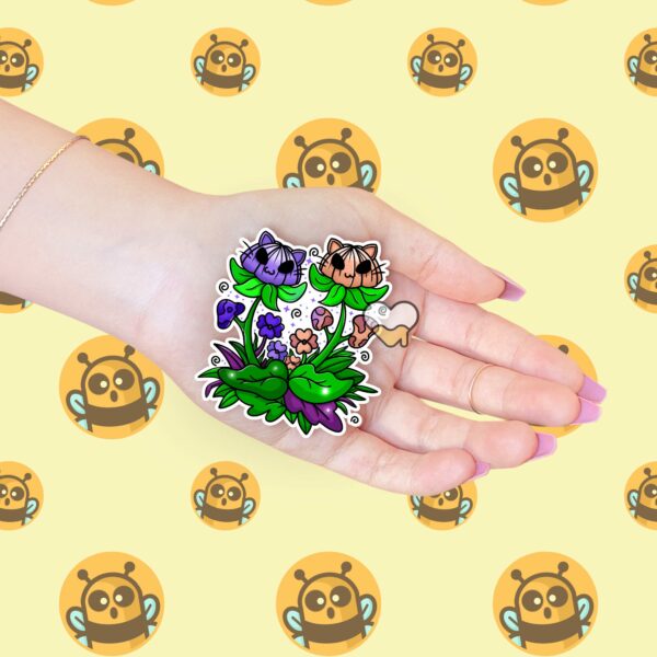 This image shows an adorable hand-drawn sticker, Play In The Weeds Sticker, which is available to purchase from HunnieByte.com